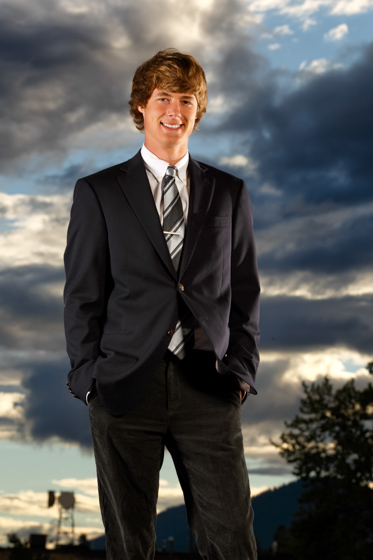 senior portrait with dramatic clouds